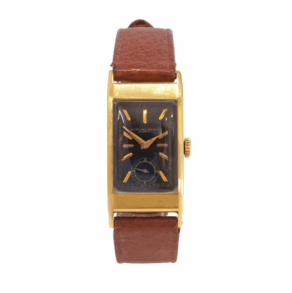 Patek Philippe Tegolino armbåndsur i 18kt guld udført i 1940erne. Skive betegnet "Patek Philippe & Co Geneve". Kassemål: 20x35mm (eksl. horn)